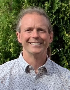 mature man with collared shirt and pony tail