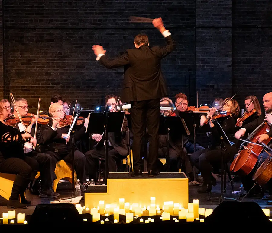 a photo of the orchestra and conductor